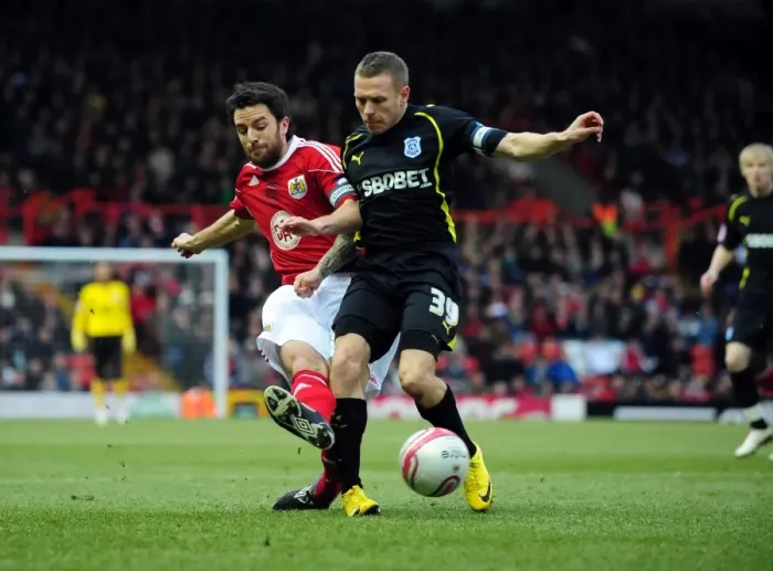 Framed Print : Battling for Supremacy: Cole Skuse vs. Craig Bellamy in the 2011 Championship Clash between Bristol City and Cardiff City