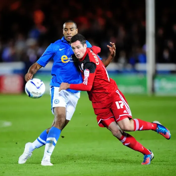 Framed Print : Battling for Supremacy: Cunningham vs Barnett in Peterborough United vs Bristol City Championship Clash Framed Print : Battling for Supremacy: Cunningham vs Barnett in Peterborough United vs Bristol City Championship Clash