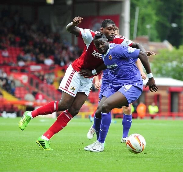 Battling for Supremacy: Jay Emmanuel-Thomas vs. Bakary Sako in Bristol City vs. Wolves Football Match