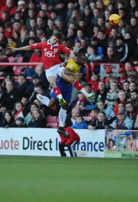 Framed Print : Battling for Supremacy: Joe Bryan's Aerial Clash in Bristol City vs Crawley Town
