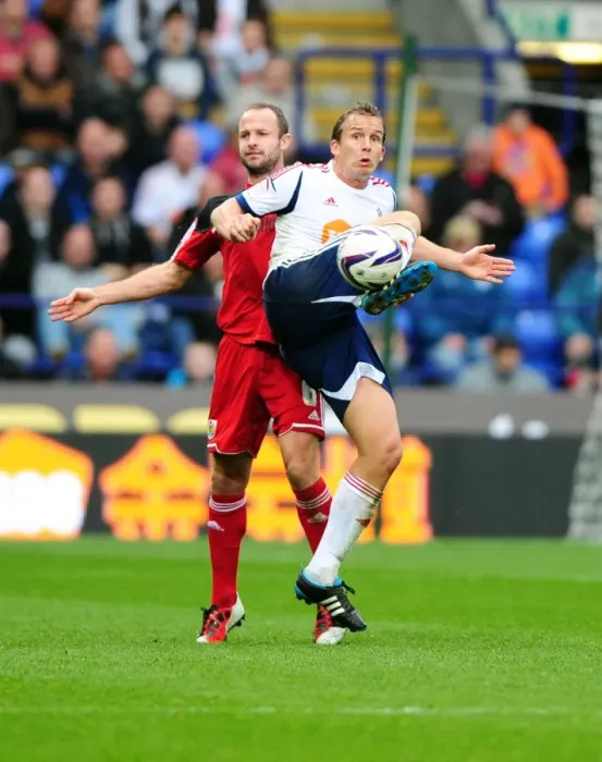 Framed Print : Battling for Supremacy: Kevin Davies vs. Louis Carey in the 2010-11 Championship Clash between Bolton Wanderers and Bristol City