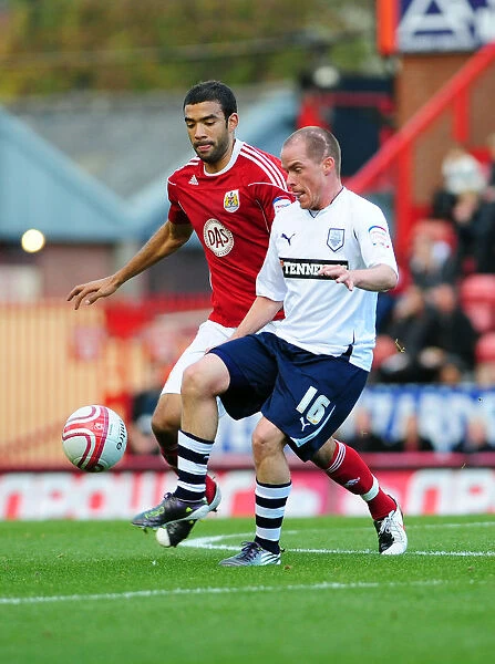 Battling for Supremacy: Liam Fontaine vs. Iain Hume in the Championship Clash between Bristol City and Preston North End