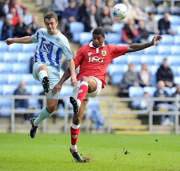 Battling for Supremacy: Mark Little vs. Danny Pugh in Bristol City's Sky Bet League One Clash at Ricoh Arena
