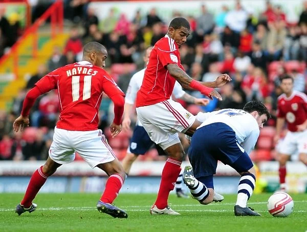 Battling for Supremacy: Marvin Elliott vs. Keith Treacy in the Championship Clash between Bristol City and Preston North End