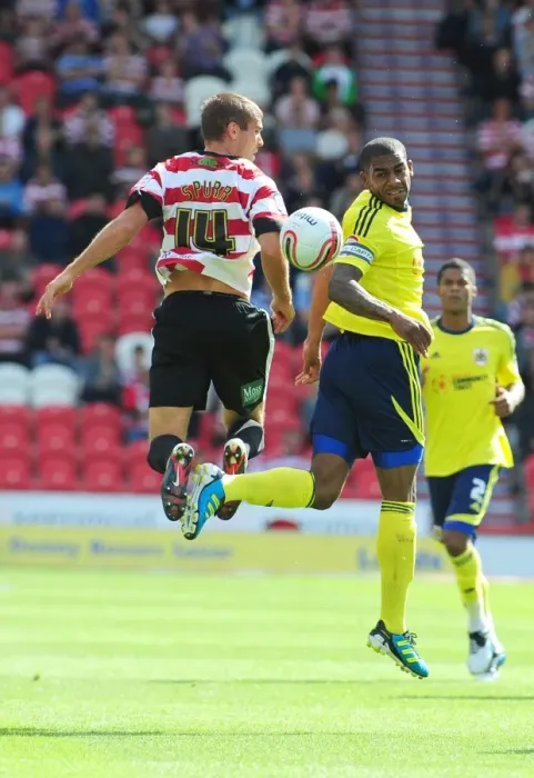 Framed Print : Battling for Supremacy: Marvin Elliott vs. Tommy Spurr in Doncaster Rovers vs. Bristol City (League Cup, 2011)