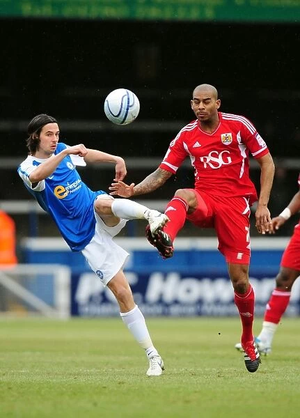 Battling for Supremacy: Marvin Elliott vs. George Boyd in Peterborough United vs. Bristol City Football Match, 2012