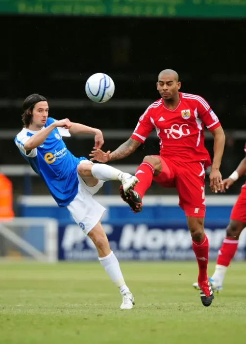 Framed Print : Battling for Supremacy: Marvin Elliott vs. George Boyd in Peterborough United vs. Bristol City Football Match, 2012