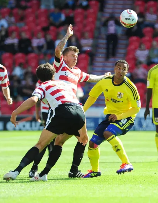 Framed Print : Battling for Supremacy: Maynard vs. Oster in Doncaster Rovers vs. Bristol City (League Cup, 2011)