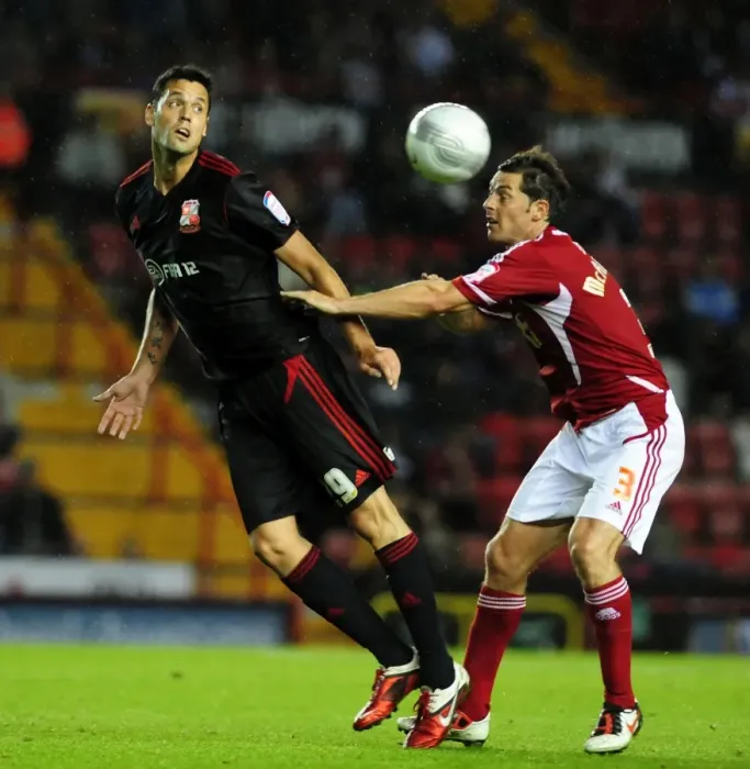 Framed Print : Battling for Supremacy: McAllister vs. Magera in the 2011 League Cup Clash between Bristol City and Swindon Town Framed Print : Battling for Supremacy: McAllister vs. Magera in the 2011 League Cup Clash between Bristol City and Swindon Town