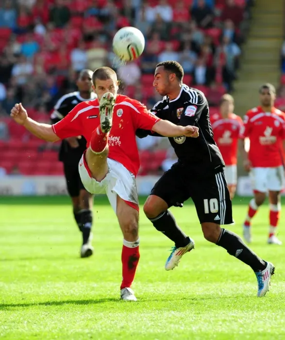 Framed Print : Battling for Supremacy: Nicky Maynard vs. Stephen Foster in the Championship Clash between Barnsley and Bristol City (09 / 04 / 2011)