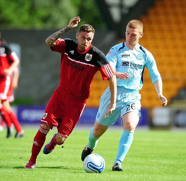 Battling for Supremacy: Paul Anderson vs. Liam Caddis in the Pre-Season Clash between St Johnstone and Bristol City