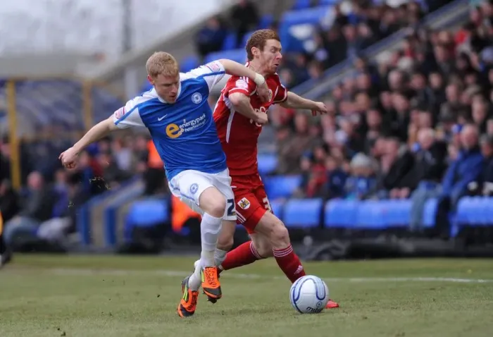 Framed Print : Battling for Supremacy: Pearson vs. Taylor - A Football Rivalry Unfolds at London Road Stadium