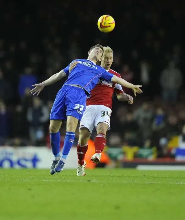 Framed Print : Battling for Supremacy: Simon Gillett vs. Daniel Philliskirk in Bristol City vs. Oldham Athletic Football Match, Sky Bet League One, 2013