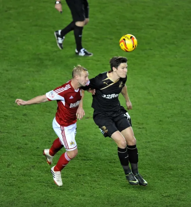 Framed Print : Battling for Supremacy: Simon Gillett vs. Josh Simpson in Cardiff City vs. Swansea City Football Match Framed Print : Battling for Supremacy: Simon Gillett vs. Josh Simpson in Cardiff City vs. Swansea City Football Match