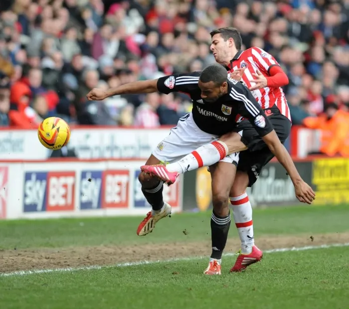 Framed Print : Bob Howard vs Tyrone Barnett: Intense Battle for the Ball in Sheffield United vs Bristol City Football Match, 2014