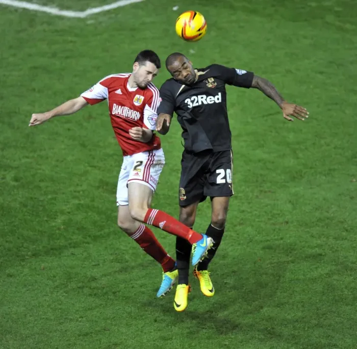 Framed Print : Brendan Moloney vs Emile Sinclair: Intense Battle for a High Ball in Cardiff City vs Swansea City Football Match