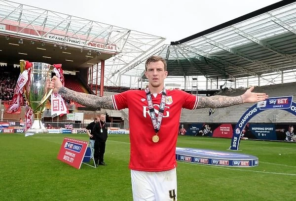 Bristol City Celebrates Promotion to Sky Bet League One with Aden Flint and the Trophy