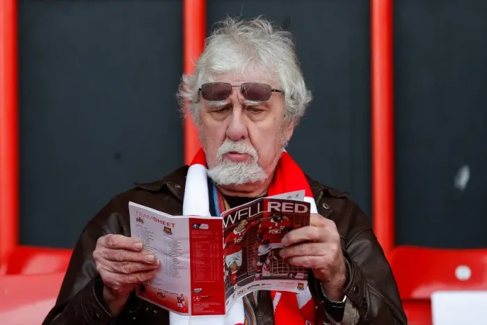 Framed Print : Bristol City Fan Peruses Match Program Before FA Cup Encounter vs. West Ham United Framed Print : Bristol City Fan Peruses Match Program Before FA Cup Encounter vs. West Ham United