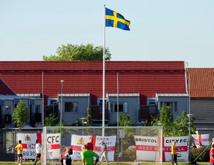 Framed Print : Bristol City fans decorate the ground with flags below the Swedish flag