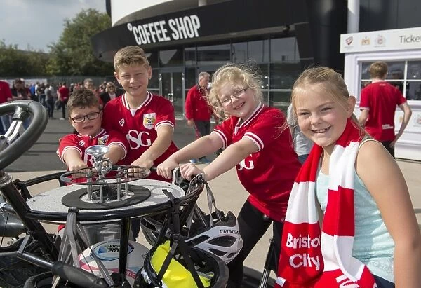 Bristol City Fans Gather Around Seven-Seater Bike for Children's Hospice South West Fundraiser at Ashton Gate Stadium