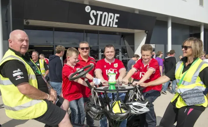 Framed Print : Bristol City Fans Ride for a Cause: Seven-Seater Bike Demonstration at Ashton Gate Stadium for Children's Hospice South West