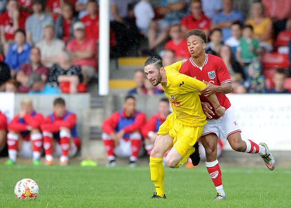 Bristol City FC: Bobby Reid Closes In on Brislington's Liam Knight During Pre-Season Friendly