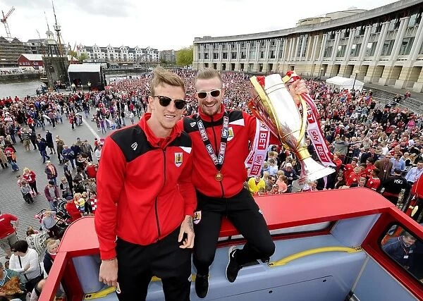 Bristol City FC: Champions Triumph - Aden Flint and Wade Elliott Hold the League One Trophy Amidst Thousands of Ecstatic Fans