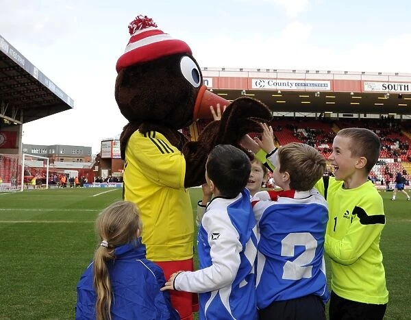 Bristol City Mascot Scrumpy Delights Young Fans at Ashton Gate during Bristol City vs Gillingham Match