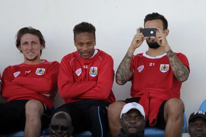 Framed Print : Bristol City Players Bobby Reid, Luke Ayling, and Marlon Pack Watching Extension Gunners vs. Bristol City Match in Gaborone, 2014