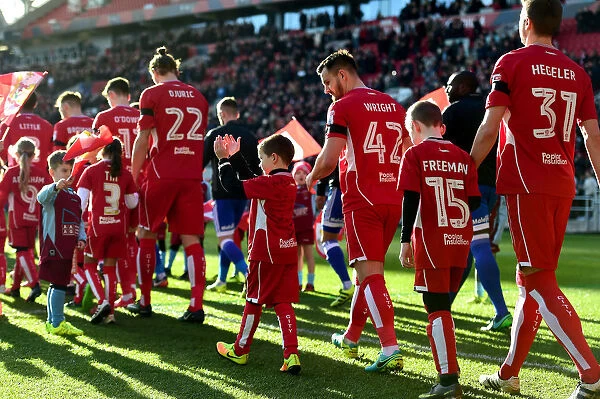 Bristol City Players and Mascots Kick Off Against Cardiff City - Championship Match