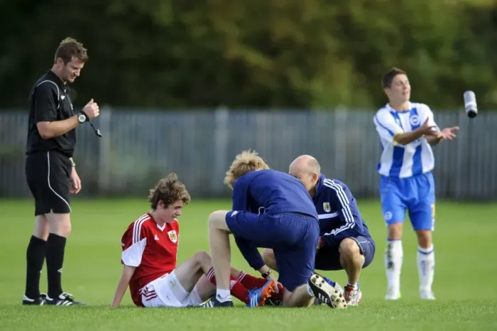Framed Print : Bristol City U18's Tom Fry Receives Medical Attention During Match Against Brighton & Hove Albion U18