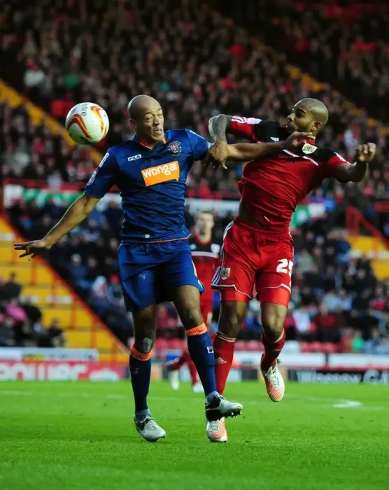 Framed Print : Bristol City vs Blackpool: Marvin Elliott vs Alex John-Baptiste Battle for Possession in Championship Match Framed Print : Bristol City vs Blackpool: Marvin Elliott vs Alex John-Baptiste Battle for Possession in Championship Match