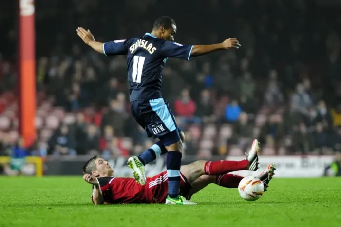 Framed Print : Bristol City vs Burnley: Mark Wilson Tackles Junior Stanislas in Championship Clash