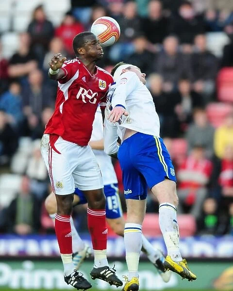 Bristol City vs. Cardiff City: Intense Aerial Battle Between Kalifa Cisse and Aaron Gunnarsson