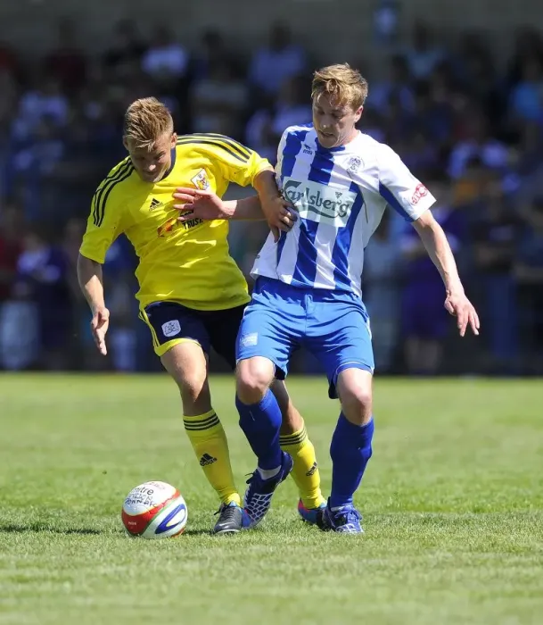 Framed Print : Bristol City vs Clevedon Town: Intense Battle Between Rhys Jordan and Adi Adams