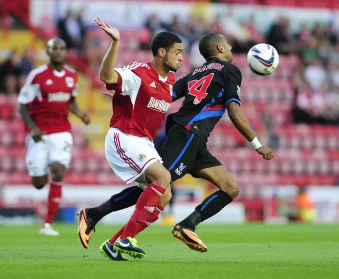 Framed Print : Bristol City vs Crystal Palace: Intense Moment as Elliot Grandin Contends with Derrick Williams Pressure