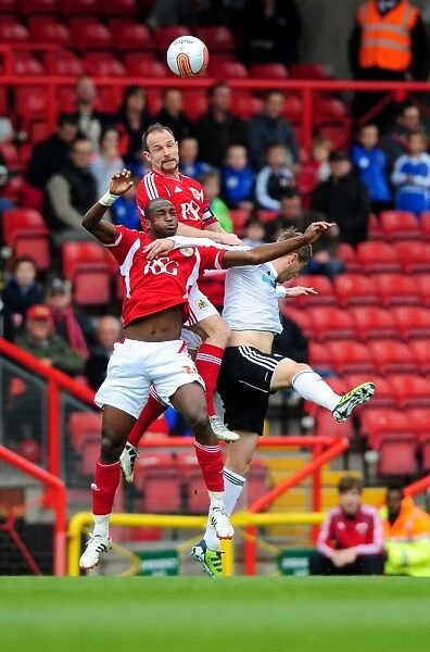 Bristol City vs Derby County: Intense Aerial Battle Between Louis Carey and Steve Davies