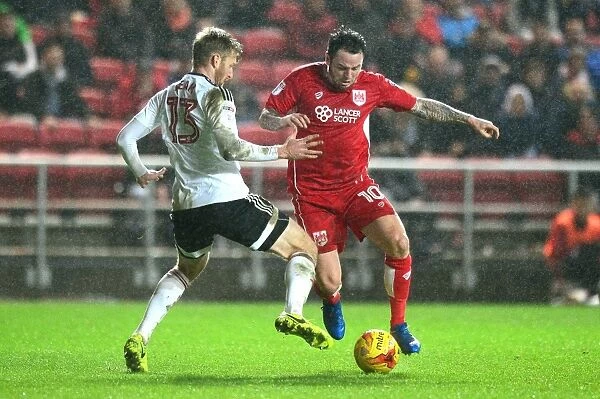 Bristol City vs Fulham: Intense Moment as Lee Tomlin Fights for the Ball against Tim Ream