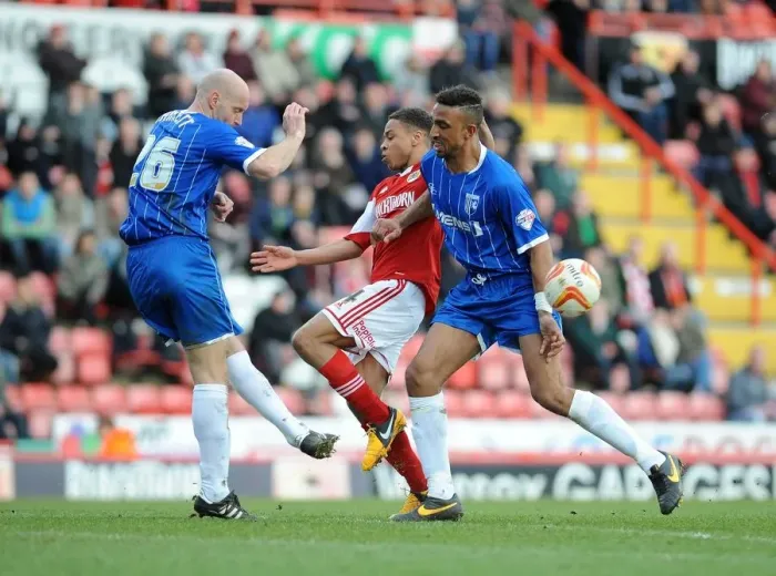 Framed Print : Bristol City vs Gillingham: Intense Moment as Bobby Reid Closes In, Adam Barrett Clears the Ball Framed Print : Bristol City vs Gillingham: Intense Moment as Bobby Reid Closes In, Adam Barrett Clears the Ball