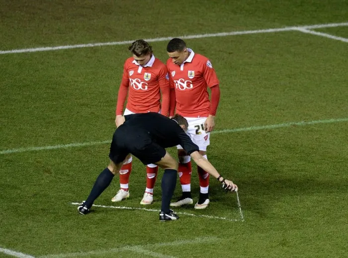 Framed Print : Bristol City vs Gillingham: Referees Marks the Line in Johnstone's Paint Trophy Showdown Framed Print : Bristol City vs Gillingham: Referees Marks the Line in Johnstone's Paint Trophy Showdown