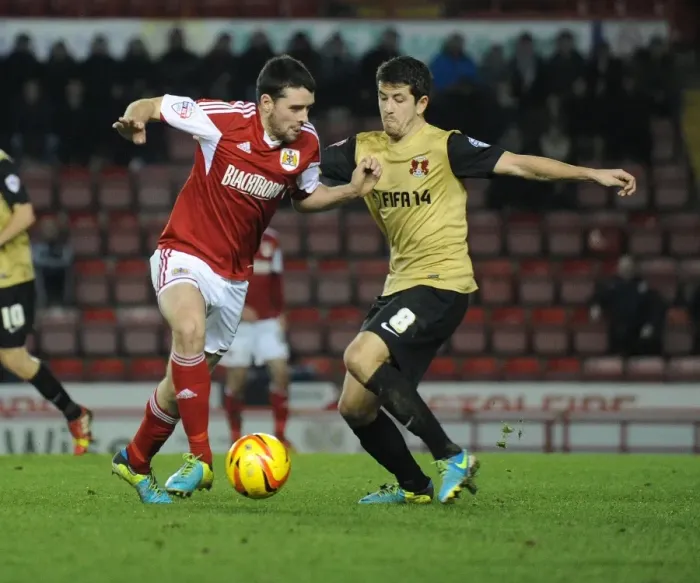 Framed Print : Bristol City vs Leyton Orient: Intense Moment as Brendan Moloney Clashes with Lloyd James