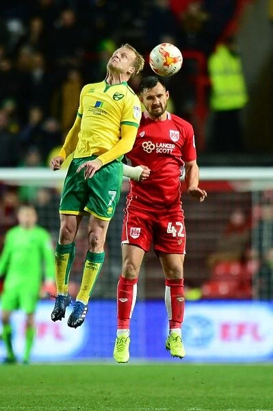 Bristol City vs. Norwich City: Intense Aerial Battle Between Bailey Wright and Steven Naismith