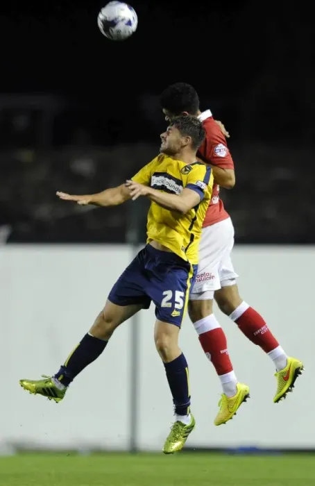 Framed Print : Bristol City vs Oxford United: Intense Aerial Battle Between Derrick Williams and Joe Riley