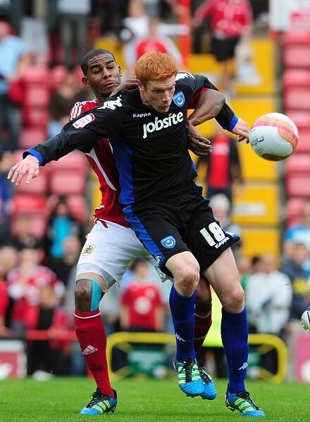 Bristol City vs. Portsmouth: Intense Battle Between Marvin Elliott and Dave Kitson in the 2008-09 Championship Match