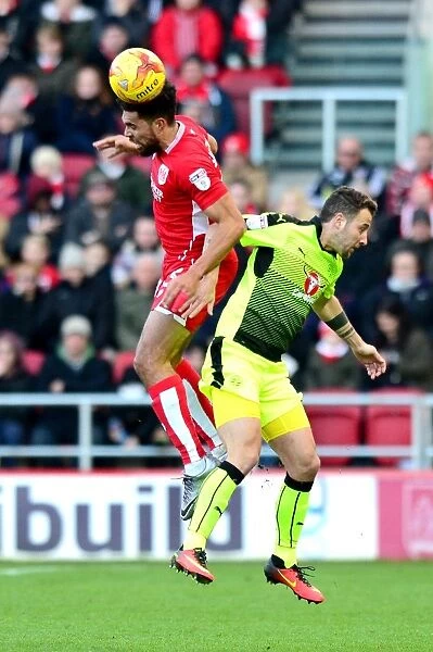 Bristol City vs Reading: Intense Aerial Battle Between Scott Golbourne and Roy Beerens