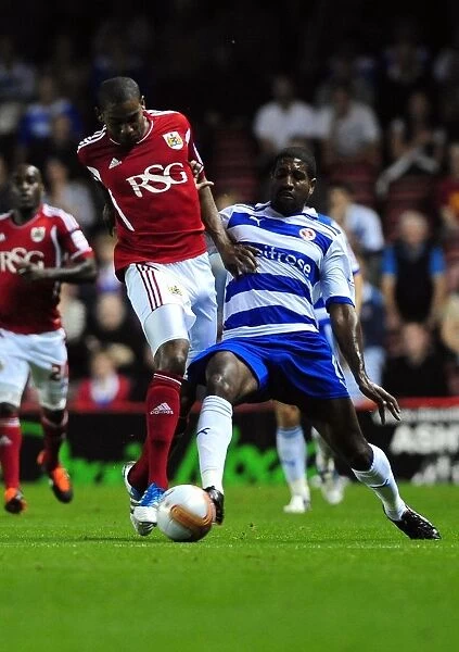 Bristol City vs. Reading: Marvin Elliott vs. Mikele Leigertwood Battle for Ball in Championship Match, September 2011