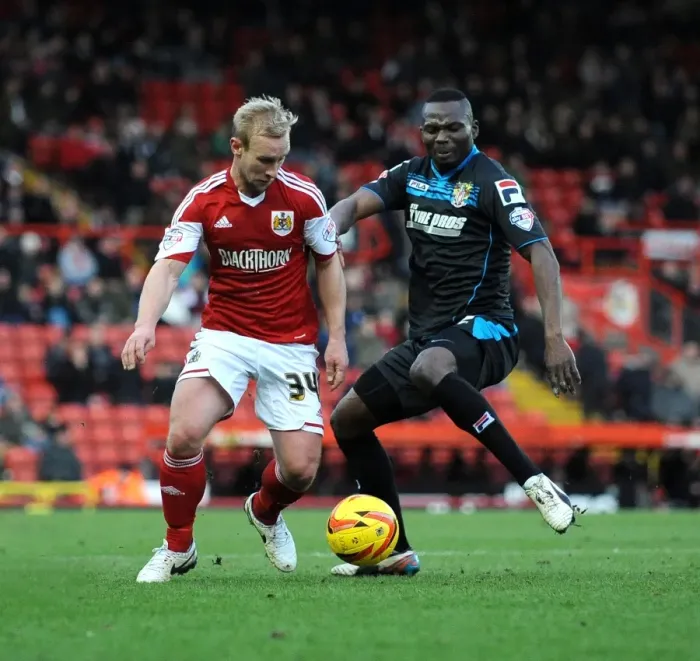 Framed Print : Bristol City vs Stevenage: Intense Moment as Francois Zoko Challenges Simon Gillett