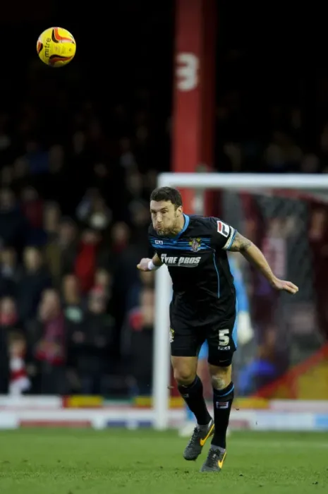 Framed Print : Bristol City vs Stevenage: Jon Ashton Heads the Ball in Sky Bet League One Clash