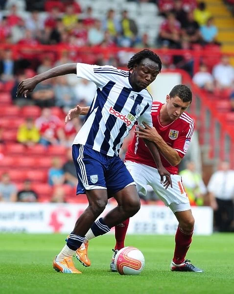 Bristol City vs. West Brom: Intense Battle Between James Wilson and Somen Tchoyi in Championship Match, 2011