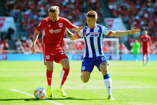 Bristol City vs Wigan Athletic: Intense Battle for the Ball between Luke Ayling and Max Power